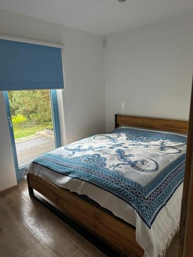 a bedroom with a bed with a blue and white quilt at Maříž 77 in Slavonice