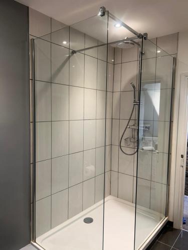 a shower with a glass door in a bathroom at No1 Townhouse - Luxury Spacious 2 bedroom townhouse, central location in Lincolnshire