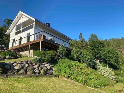 a large house on top of a hill at Idyllic Lake House - 4 rooms & 2 Glamping Tents Available in Porsgrunn