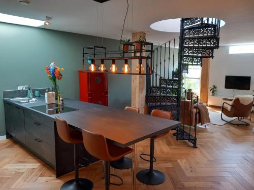 a dining room with a table and a staircase at Luxurious house close to the center of Amsterdam in Oostzaan