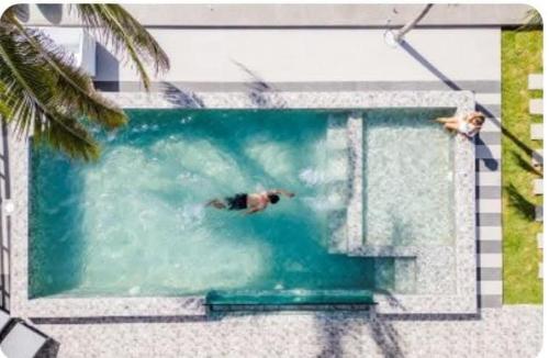 a man is swimming in a swimming pool at ON THE BEACH Beach Front in Ban Tha Sai