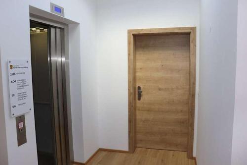 a wooden door in a room with a wooden floor at Exklusiv Apartment Trattberg in Vöcklabruck