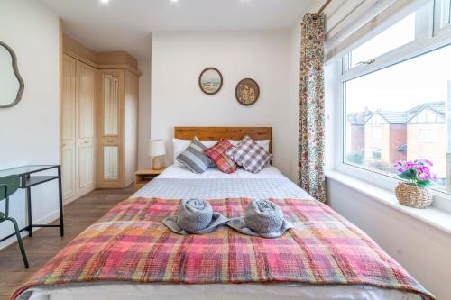 a bedroom with two stuffed animals sitting on a bed at Beautiful Three Bedroom House - Manchester Escape in Manchester