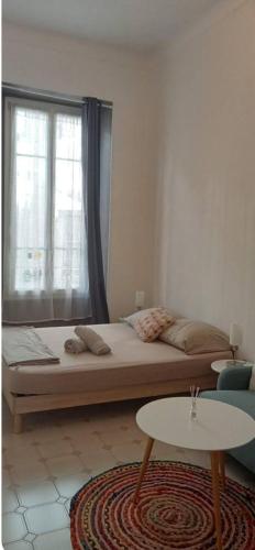 une chambre avec un lit avec une fenêtre et une table dans l'établissement Apartement Coeur Nice Ville ! Zone Touristique !, à Nice