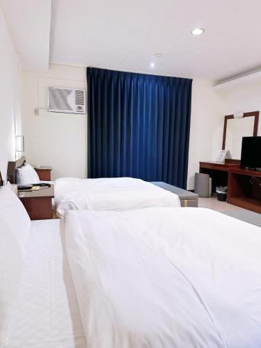 Ένα ή περισσότερα κρεβάτια σε δωμάτιο στο Hua Du Motel