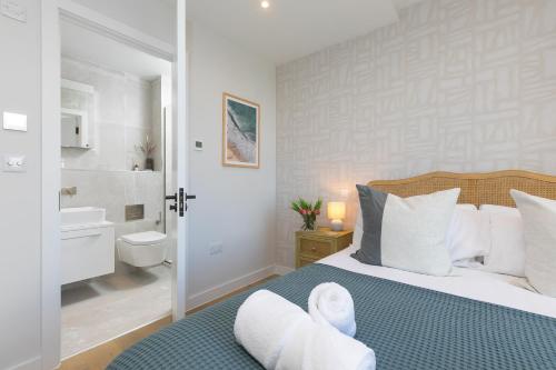 a bedroom with a bed and a bathroom at 14 An Garth in Hayle
