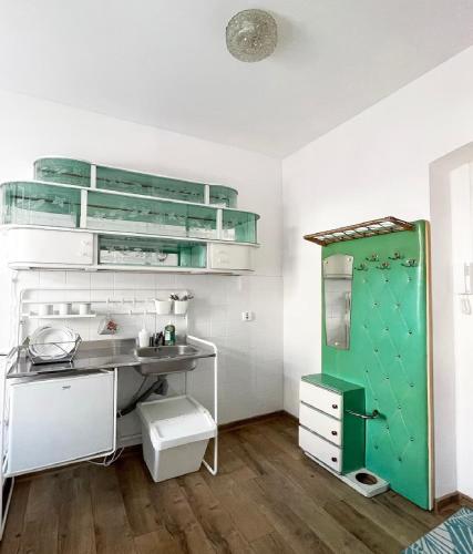 a bathroom with a green cabinet and a sink at Apartment Katowice Center - Słowackiego in Katowice