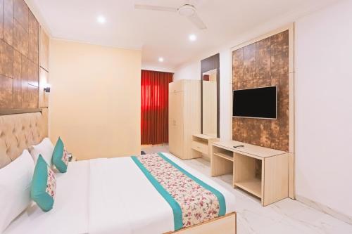 a hotel room with a bed and a television at HOTEL SHYAM INTERNATIONAL - NEAR TERMINAL 3 DELHI AIRPORT WITH - Free AIRPORT PICKUP in New Delhi