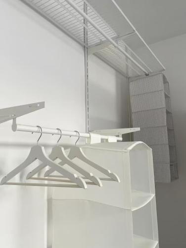 a white kitchen with a table and a shelf at Apartment Katowice Center - Słowackiego in Katowice