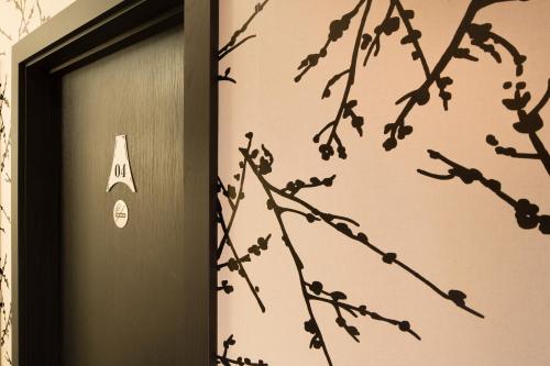 a door with a sign on the side of it at Hôtel Le M in Paris