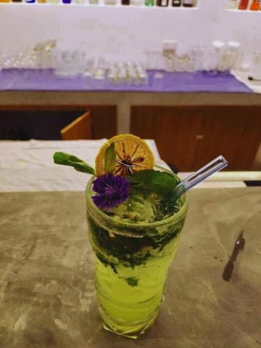 a glass vase with a flower in it on a table at Three Trees Samui Resort - Sarocha Villa in Lamai