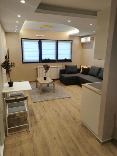 a living room with a couch and a table at Airport Nest Belgrade in Novi Beograd