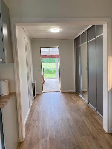 an empty hallway with a door open to a room at Fully equipped country house with lake location in Eksjö