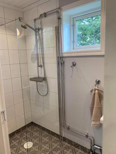 a shower with a glass door in a bathroom at Fully equipped country house with lake location in Eksjö
