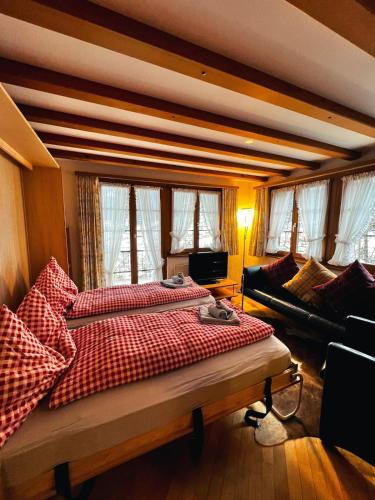 a bedroom with a large bed and a couch at Apartment Aphrodite West magnificent Eiger view in Grindelwald