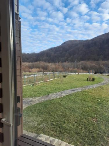 a view of a field from a window at Villa Opir in Skole