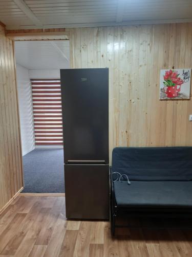 a room with a couch in a room with wooden walls at Villa Opir in Skole