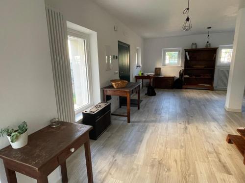 an empty living room with wooden floors and a piano at B&B La Marjolaine di Ale e Madda in Fagagna