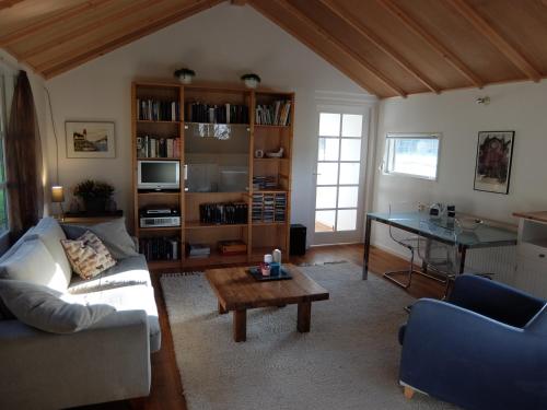 a living room with a couch and a table at Holiday home Giethmen in Giethmen