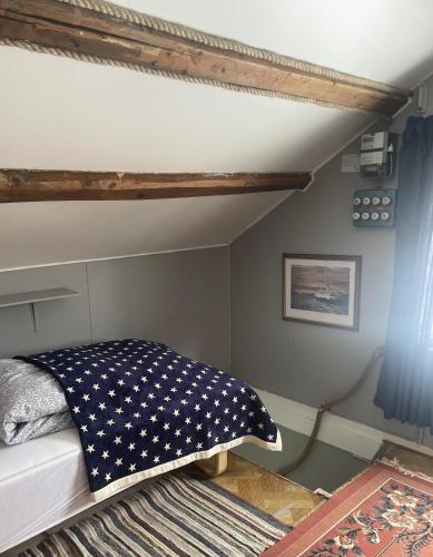 a bedroom with a bed with a pillow on it at Hanøya- Vesterålen in Myrland