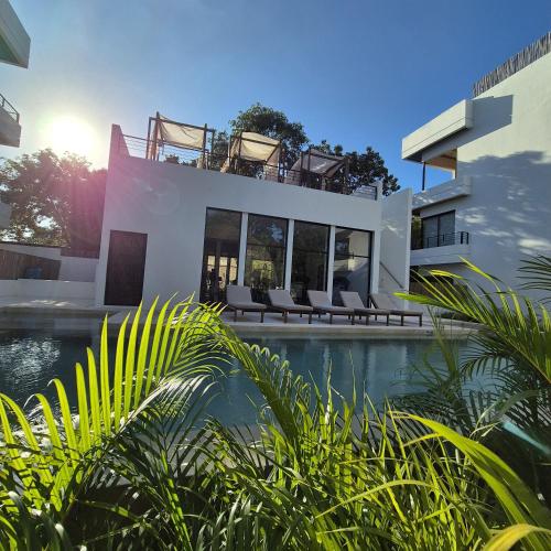 a house with a swimming pool next to a building at New luxury studio with plunge pool in Tulum