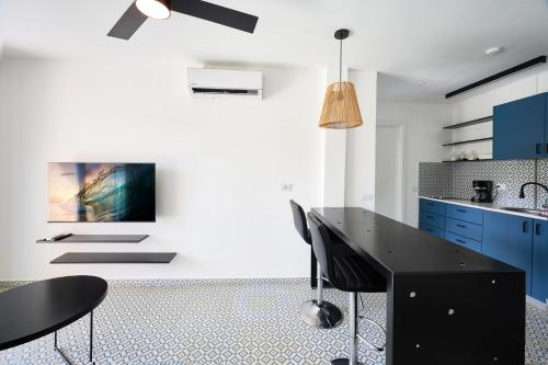 a kitchen with a black table and blue cabinets at Homz Venao in Playa Venao