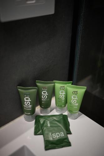 a group of four green products sitting on a counter at Homz Venao in Playa Venao
