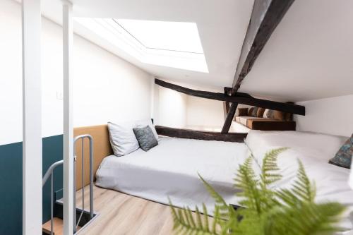 une chambre avec deux lits dans une pièce dans l'établissement Sous les étoiles a Montreuil, à Montreuil