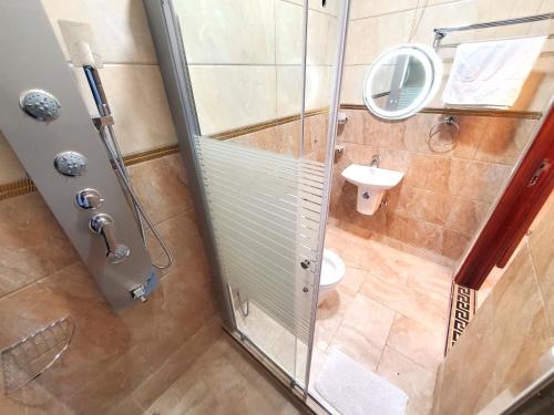 a small bathroom with a shower and a toilet at Serene Courts Kitende in Kitende