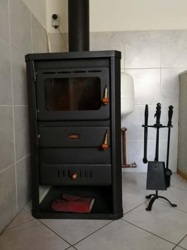 a fireplace with a stove in a room at Petrovická chalupa in Petrovice u Susice