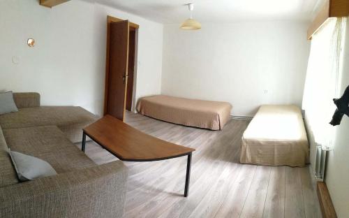 a living room with two beds and a couch at Petrovická chalupa in Petrovice u Susice