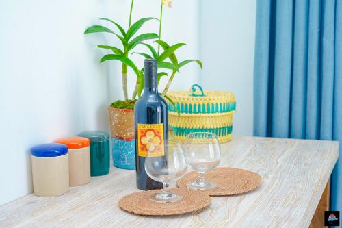 a bottle of wine and two glasses on a table at Beach Symphony in Mount Lavinia