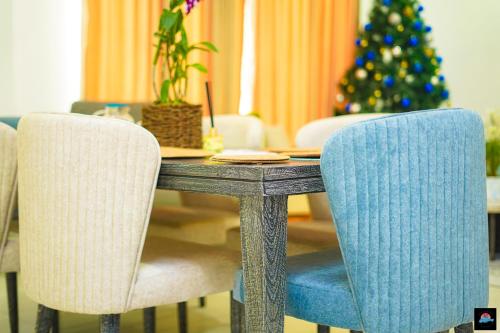 a dining room table with two chairs and a christmas tree at Beach Symphony in Mount Lavinia