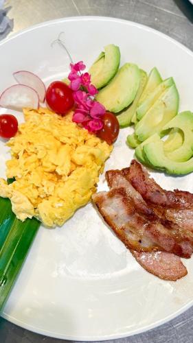a white plate of food with eggs meat and vegetables at Cape Beach Villa Samui in Ban Bang Po