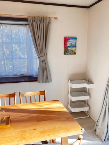 a room with a wooden table and a window at リサの家 in Nasu-yumoto