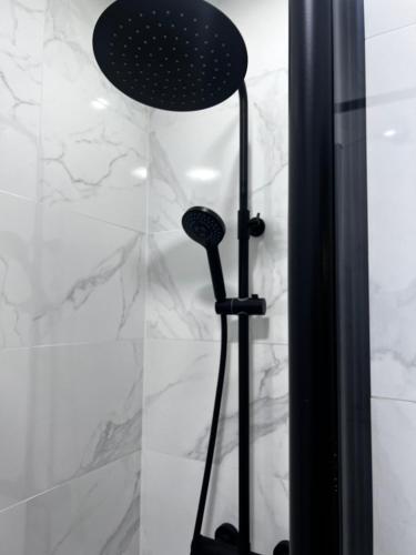 a shower with a black lamp in a bathroom at Casa Cuchariños Louro in Louro