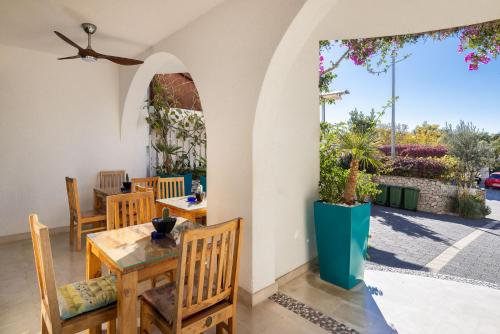 a dining room with a table and chairs and a patio at Apartments POLARIS in Baška Voda