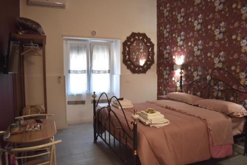 a bedroom with a bed and a table and a window at Dolce Vita House in Pontecagnano