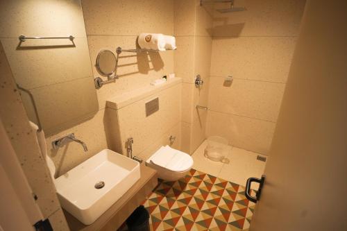 a small bathroom with a sink and a toilet at RIVERSCAPES by NOORJEHAN in Palakkad