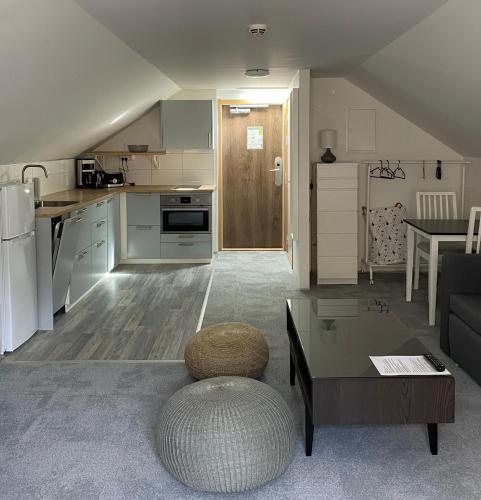 a kitchen and a living room with a couch and a table at Forenom Hostel Gothenburg Säve in Gothenburg