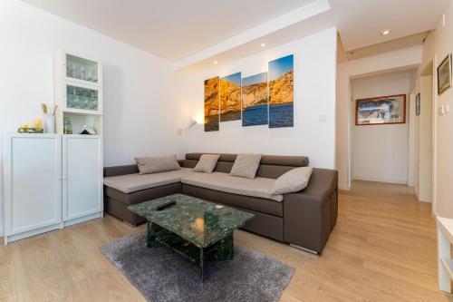 a living room with a couch and a table at MY DALMATIA - Villa Sucic with private pool and mountain view in Obrovac