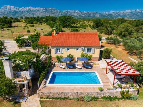 an aerial view of a house with a swimming pool at MY DALMATIA - Villa Sucic with private pool and mountain view in Obrovac