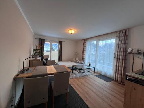 un soggiorno con tavolo da pranzo e una camera da letto di Chalet Ester a Bad Hofgastein