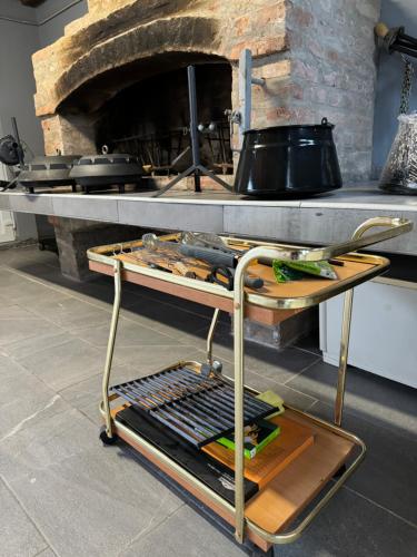 a cart in a kitchen with a stone oven at Oaza Mira Laze - Luxury Private Villa with Pool, Football Field in Nova Gradiška