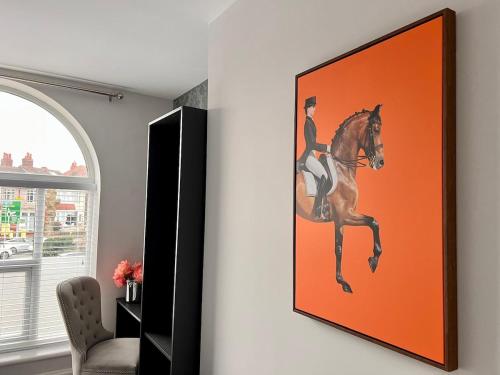 a painting of a woman riding a horse on a wall at Stunning 2 bedroomed apartment on Allerton Road, Sleeps 4 in Liverpool