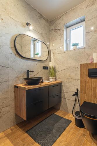 a bathroom with a sink and a mirror at Willa Dream II Resort & Spa in Krynica Zdrój