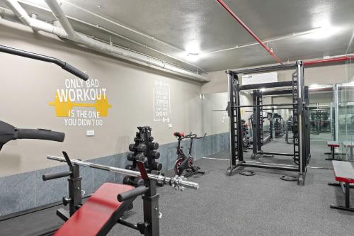 a gym with bikes and equipment in a room at 22Land Cosmos Hotel in Hanoi
