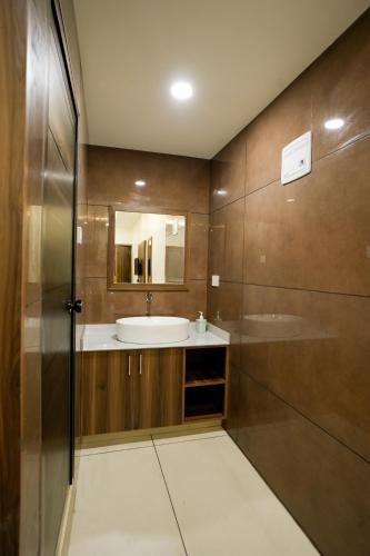 a bathroom with a sink and a mirror at Grand View Residency in Nīleshwar