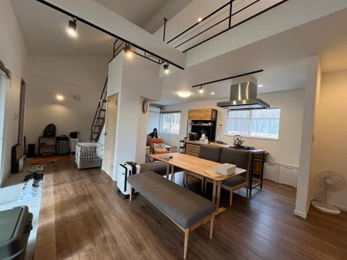 a kitchen and living room with a table and chairs at BBQ可 ワンちゃんok ロフト付き平屋を貸切で楽しむ特別な空間 ハチん家 in Hokuto
