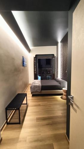 a bedroom with a bed and a bench in a room at MYO Cagliari Charming House in Cagliari